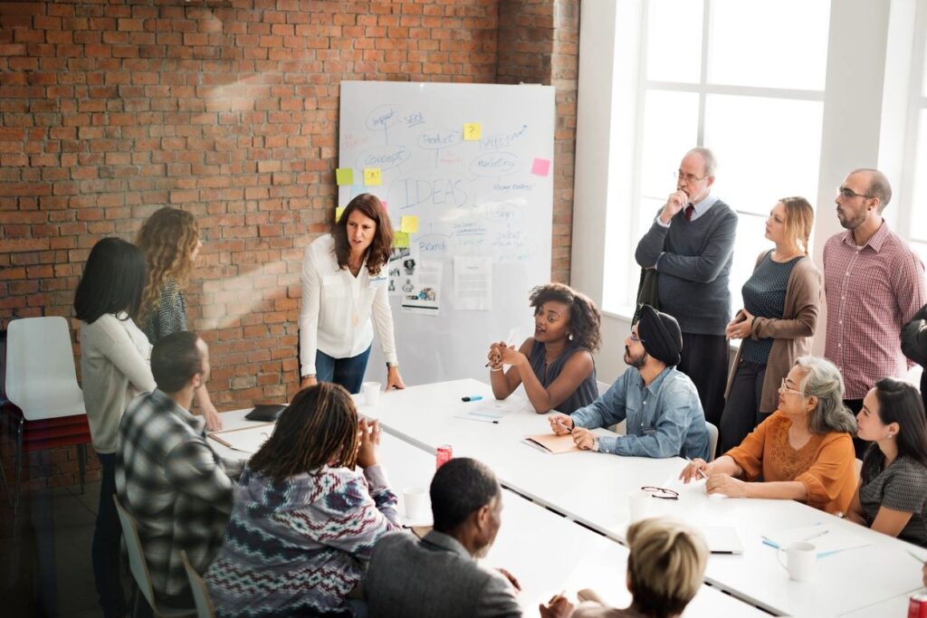 A woman presenting ideas to a team in a meeting room.